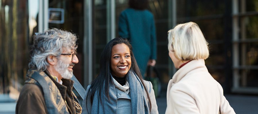 business-people-smiling-while-talking-outside-offi-VTEDGMP.jpg